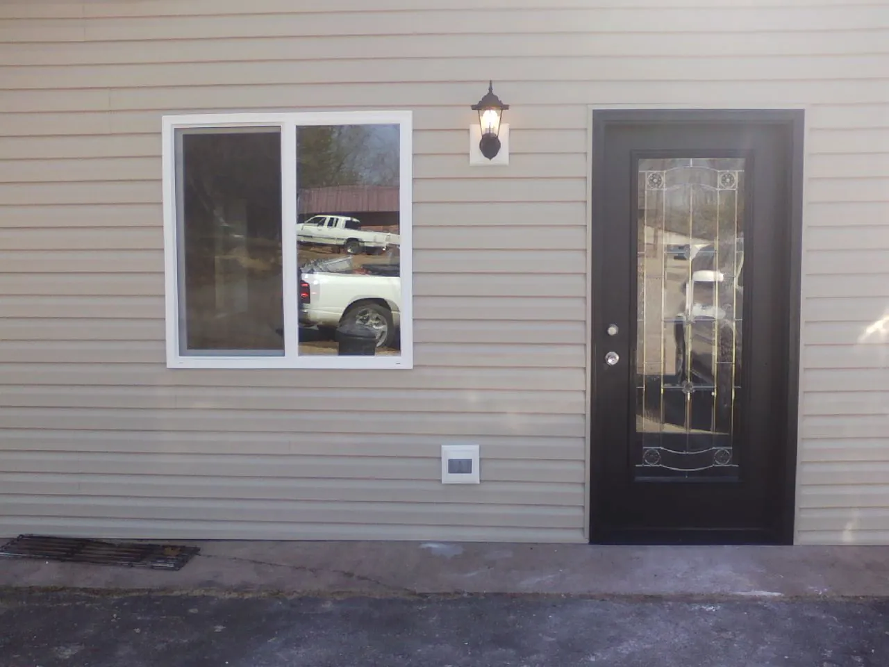 New siding, window and entry door on the side of an addition in Hutchinson